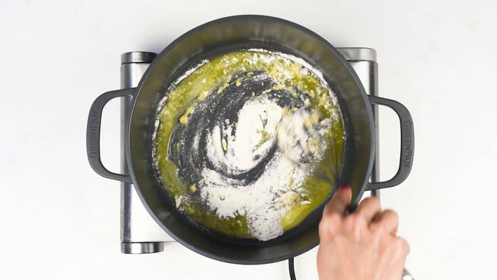 making a roux with flour and butter in a pot