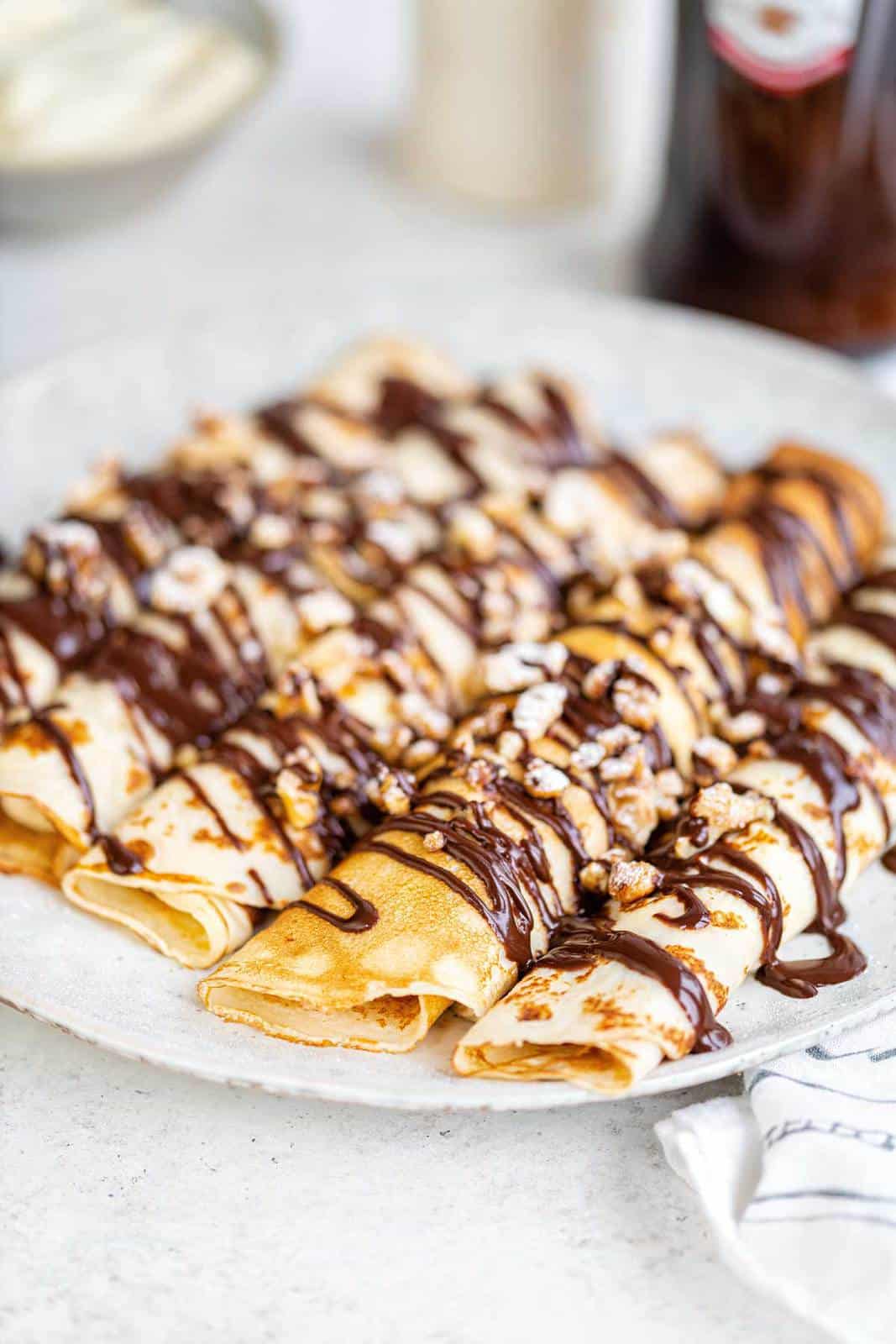 English pancakes filled with double cream and drizzled with chocolate and chopped walnuts