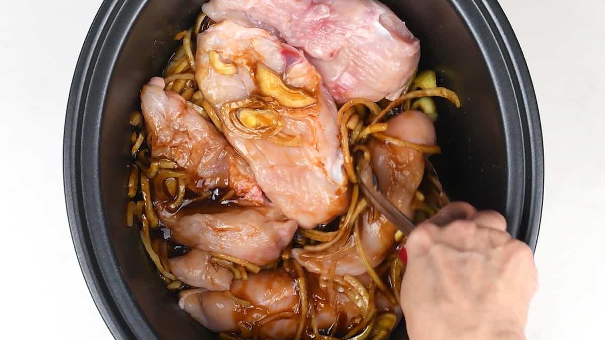 Adding chicken breasts to slow cooker for teriyaki chicken