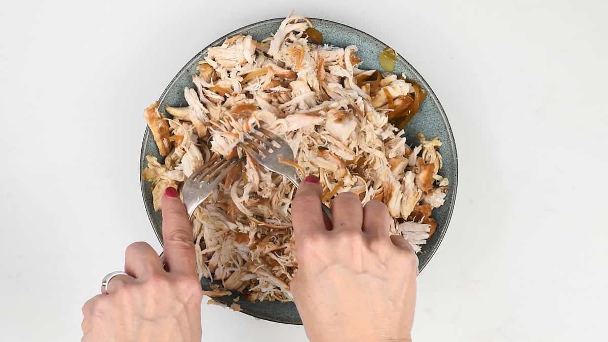 shredding slow cooked chicken using two forks
