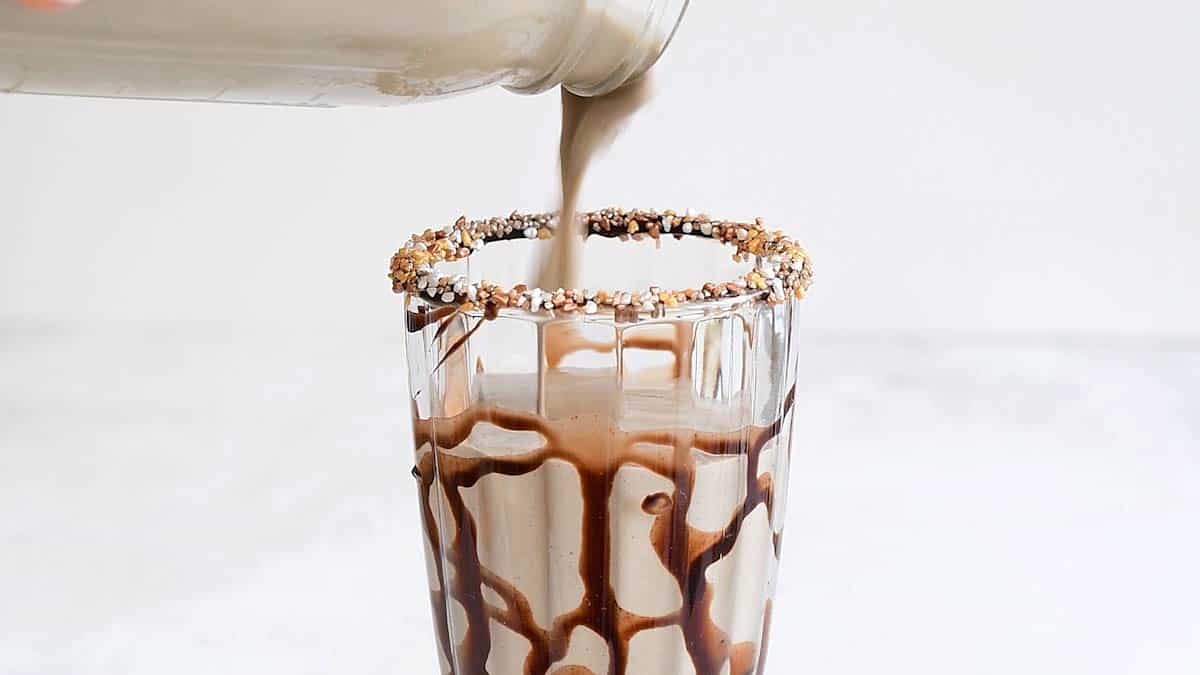 pouring milkshake into sundae glass