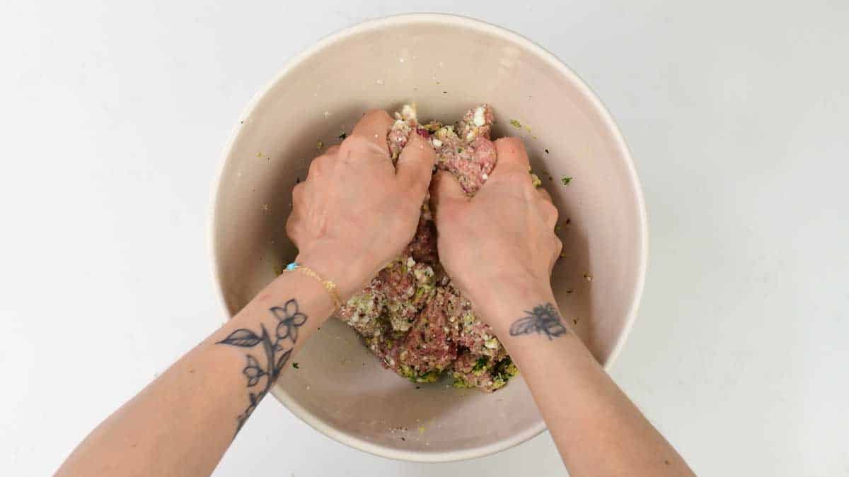 mixing ingredients for meatballs in a bowl