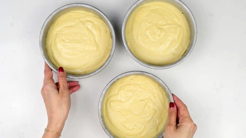 Three cake tins filled with batter