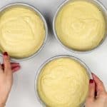 Three cake tins filled with batter