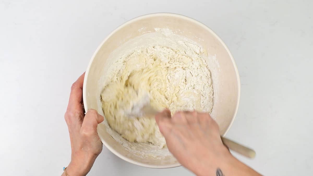 Mixing banana bread batter in a bowl
