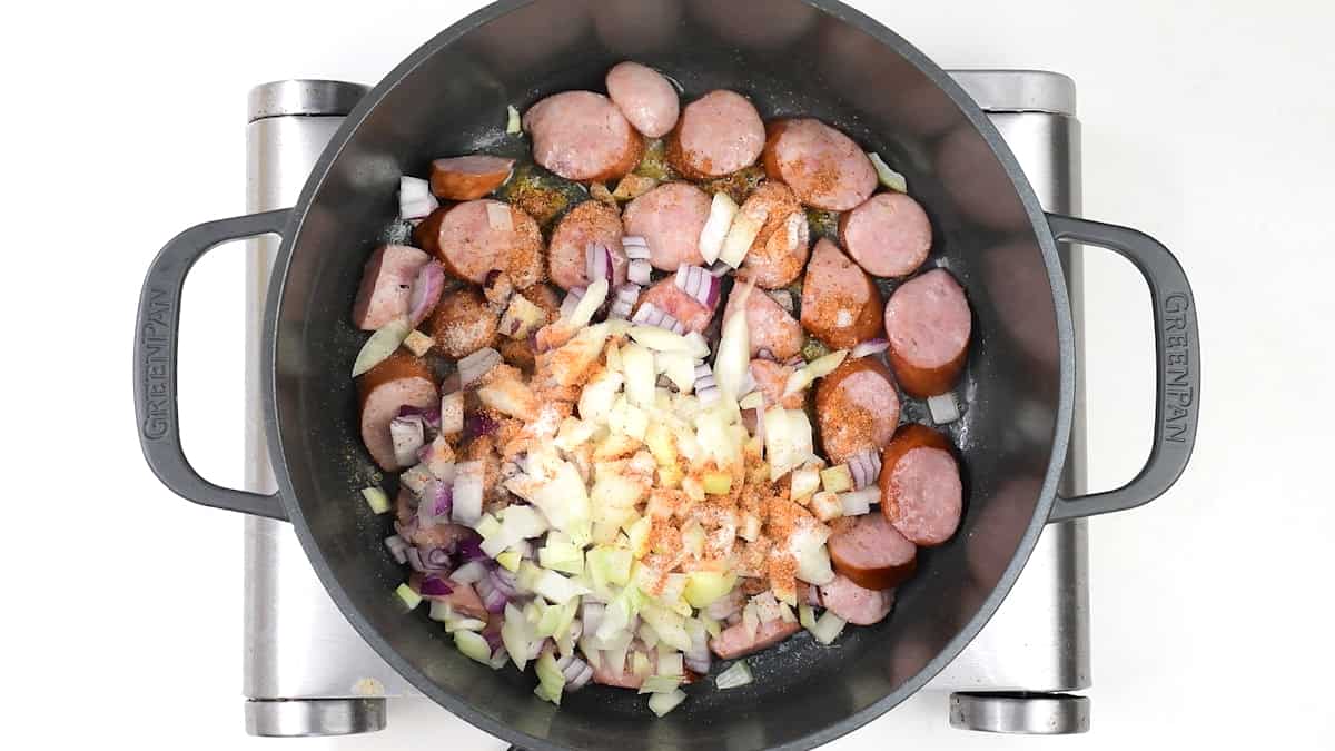 onions, sausages and seasoning in a pot
