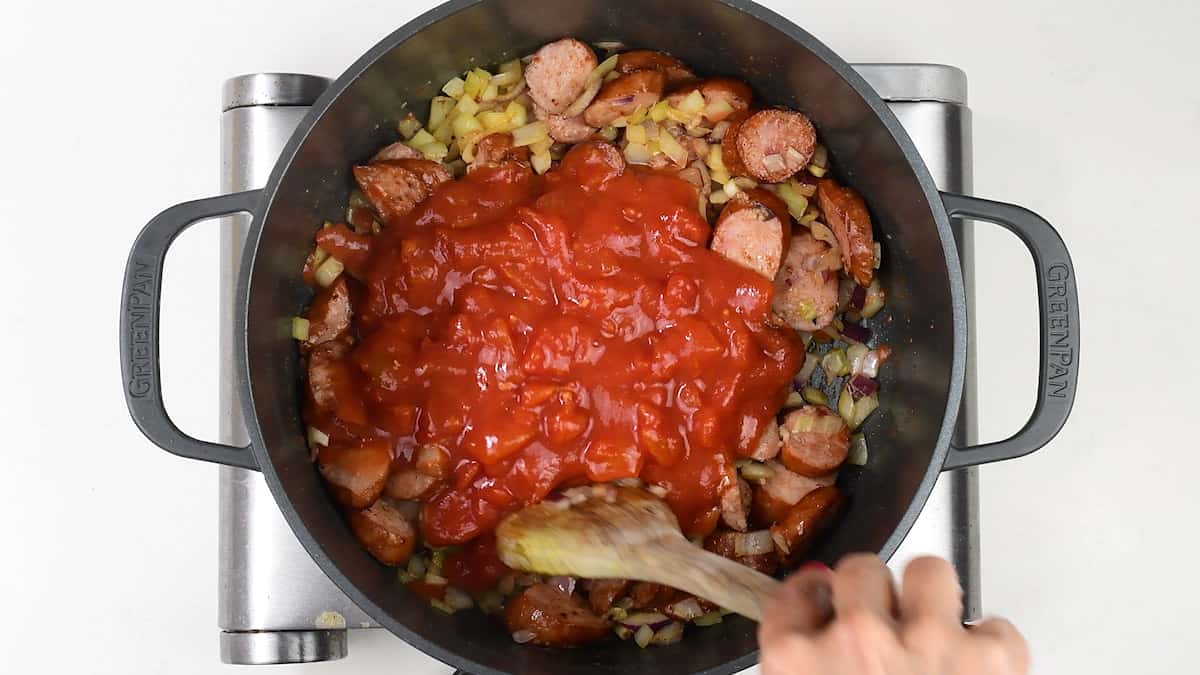 cooking tomato and sausage pasta sauce in a pot