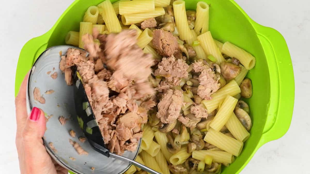 stirring tinned tuna into pasta