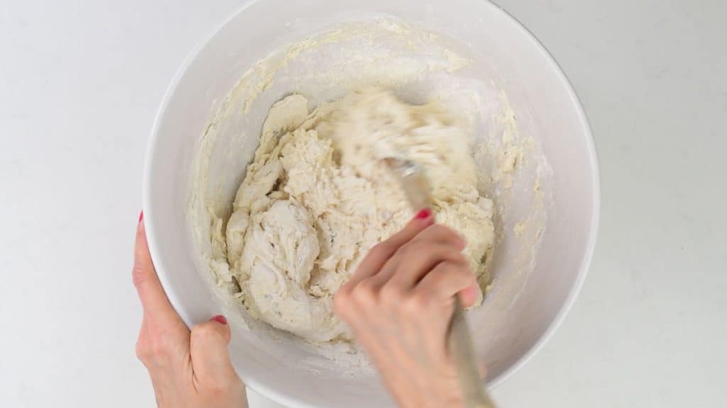 mixing pita bread dough in a bowl