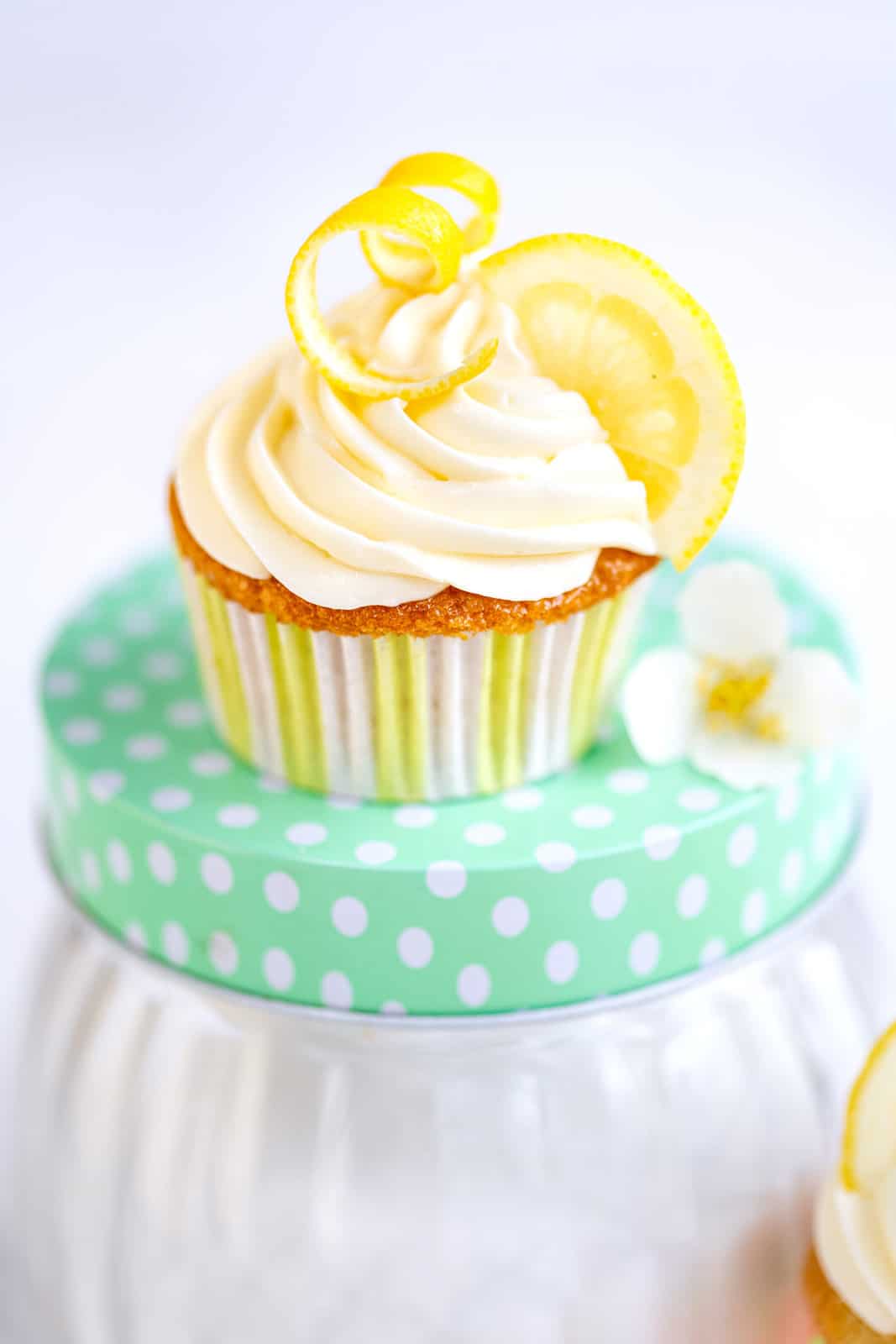 Lemon Cupcake with cream cheese frosting garnished with a twist of lemon peel and lemon slice