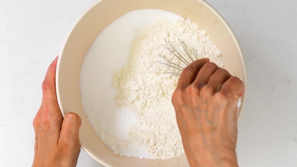 mixing flour and sugar in a bowl