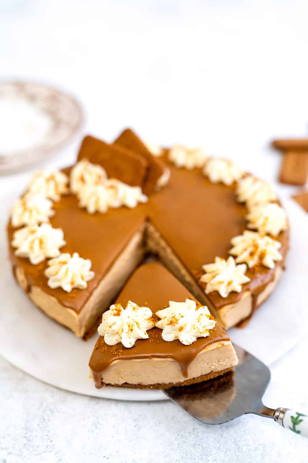 Taking a slice out of a no bake Biscoff cheesecake