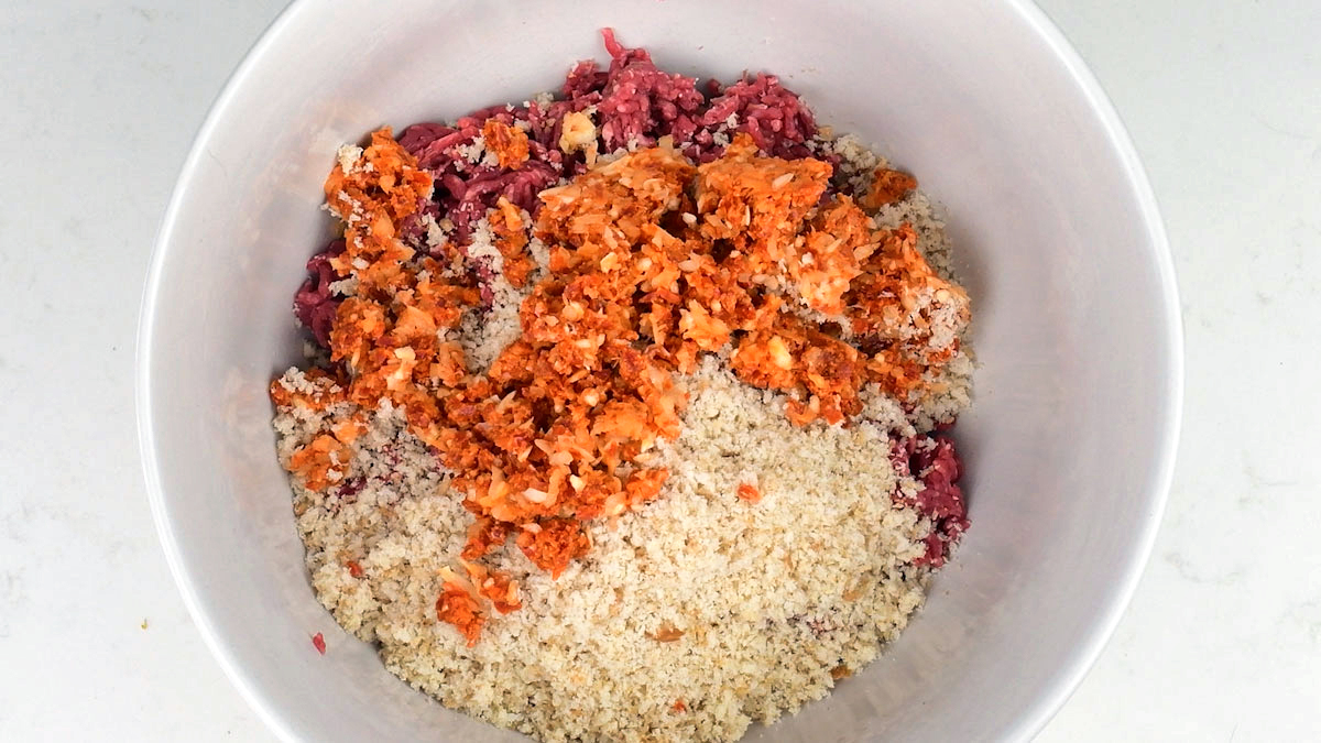 ground meat, breadcrumbs, minced chorizo and shallots in a mixing bowl