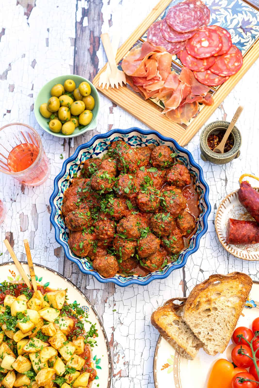 Spanish meatballs in a ceramic bowl as part of a tapas spread