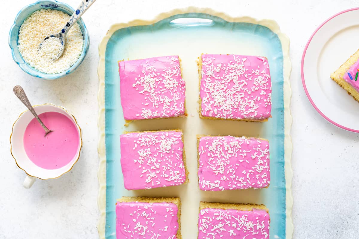 overhead view of sliced sheet cake with pink icing