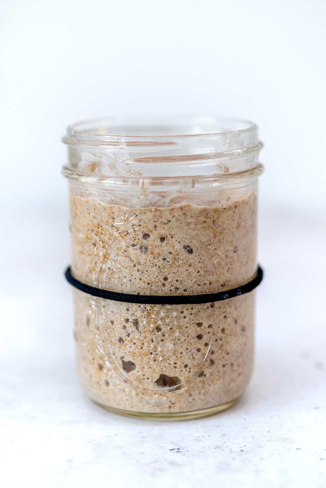 Active and bubbly sourdough starter in a glass jar
