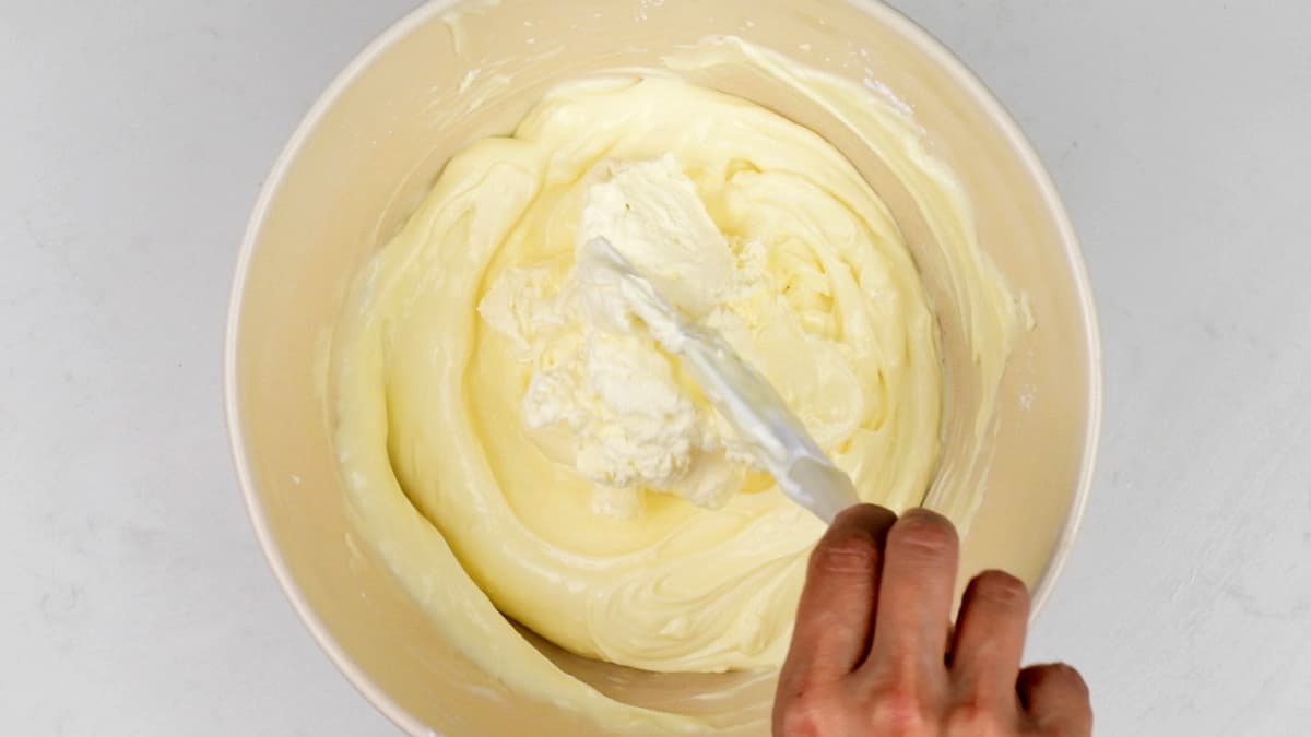 folding whipped cream into cheesecake filling