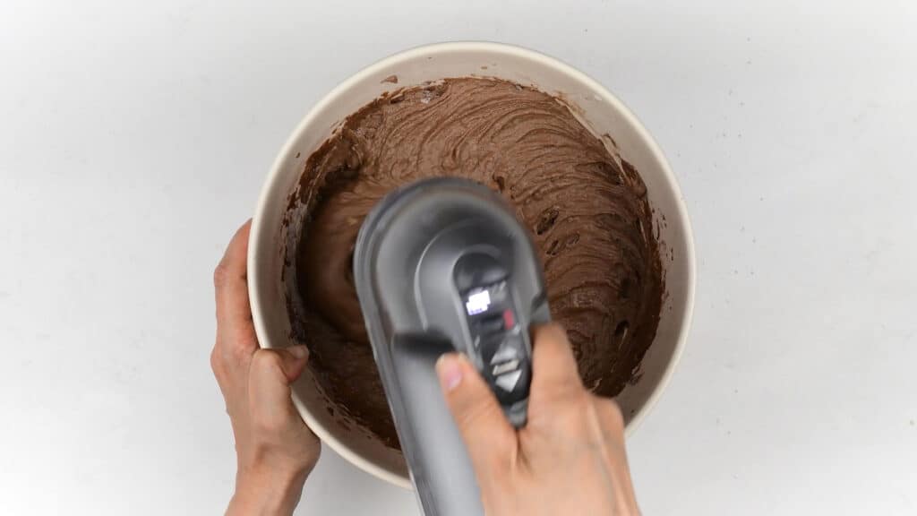beating cake batter with an electric hand mixer