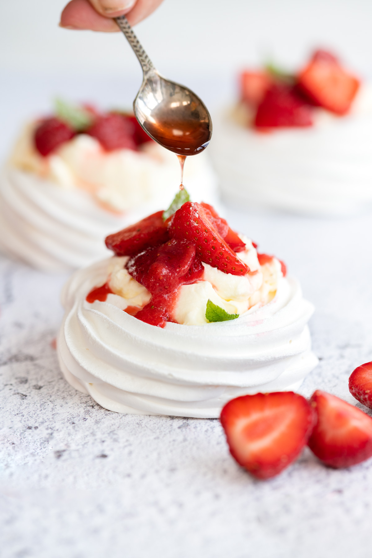 Mini pavlova filled with whipped cream and strawberries