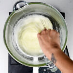heating egg whites and sugar over a double boiler