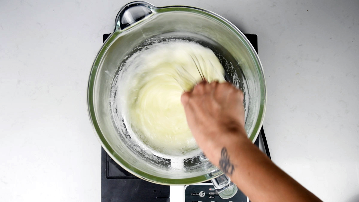 stirring egg whites and sugar over a double boiler