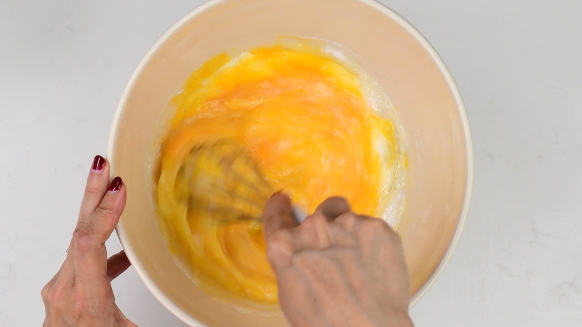whisking eggs and sugar together in a bowl