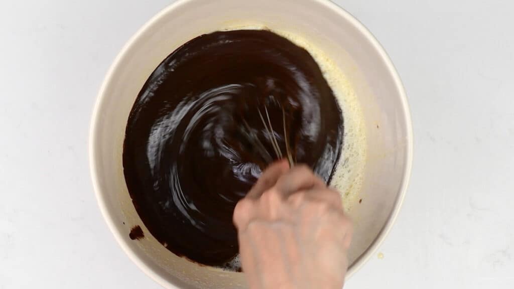 stirring melted butter and chocolate in a bowl