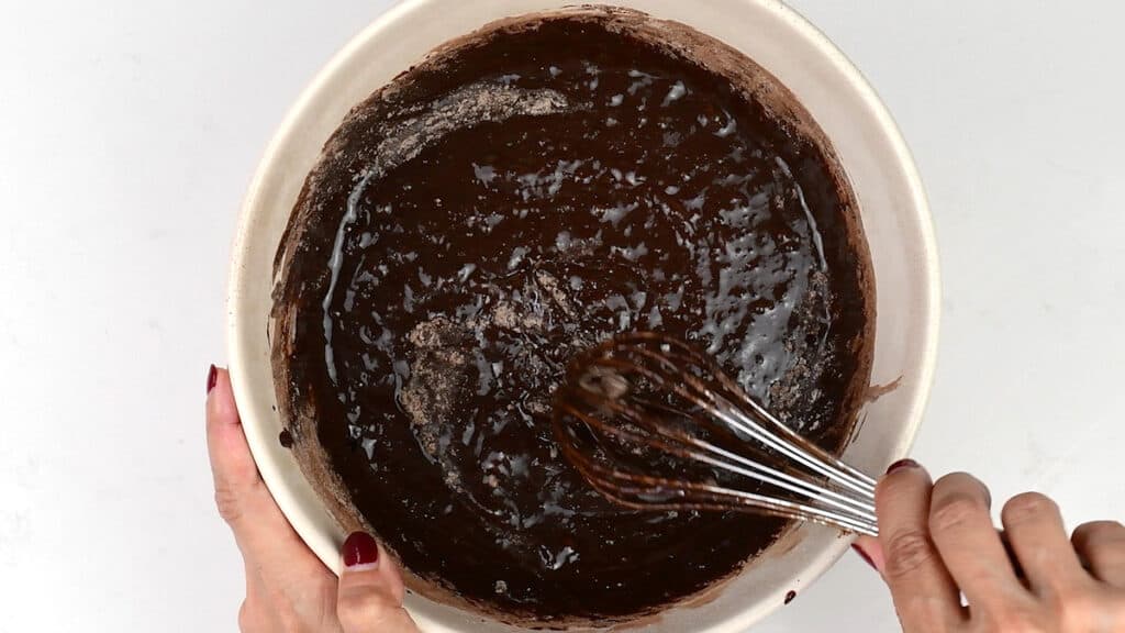 Stirring brownie batter in a mixing bowl