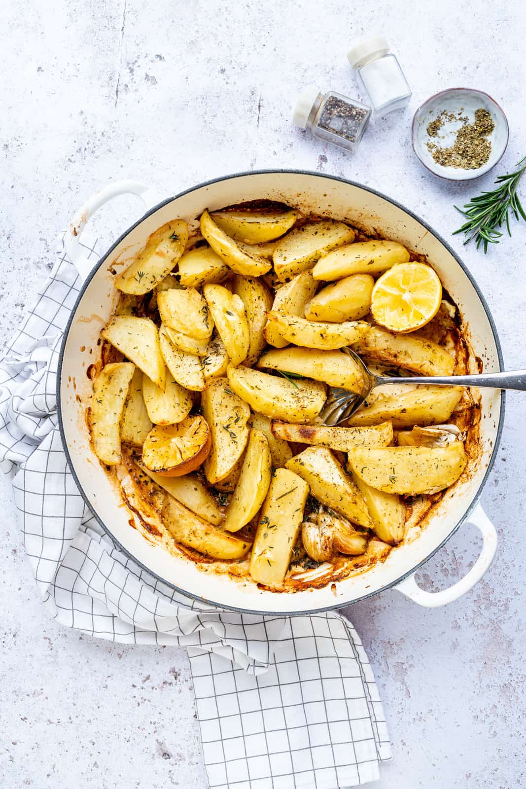 Greek Lemon Roast Potatoes in a shallow cast iron casserole