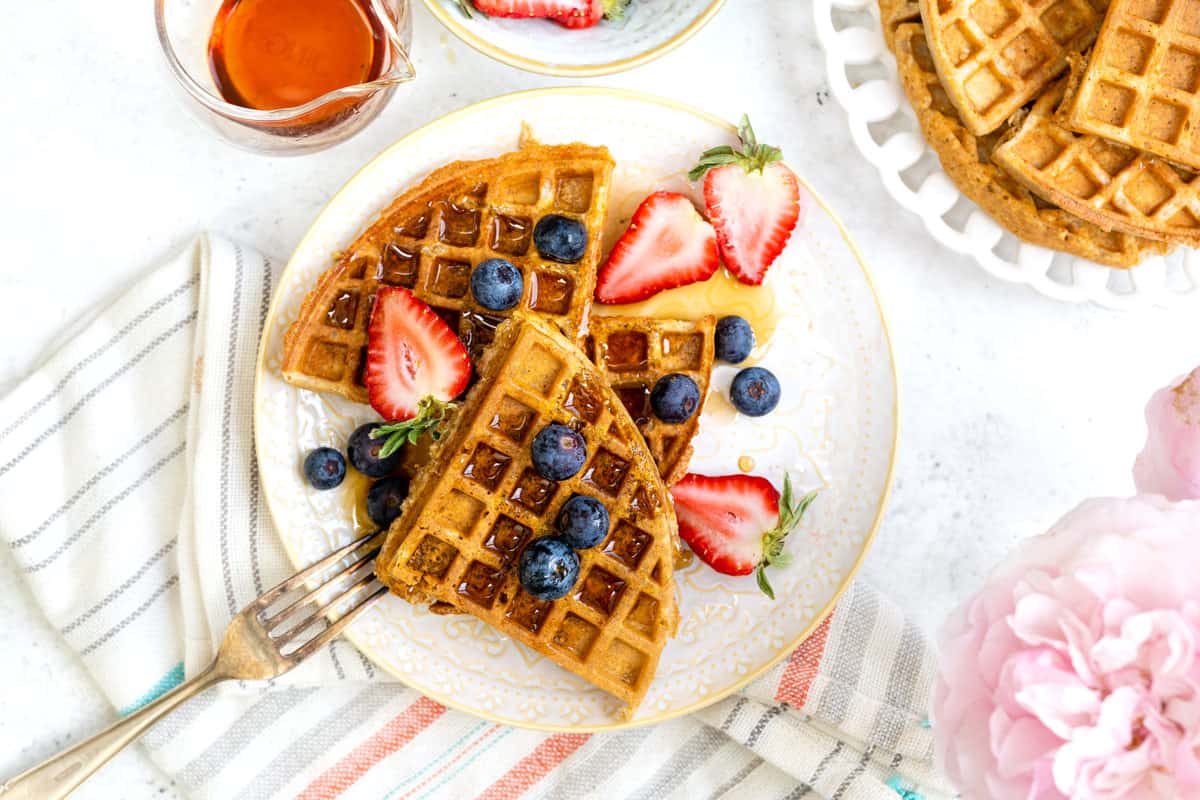 Waffles served with strawberries, blueberries and maple syrup