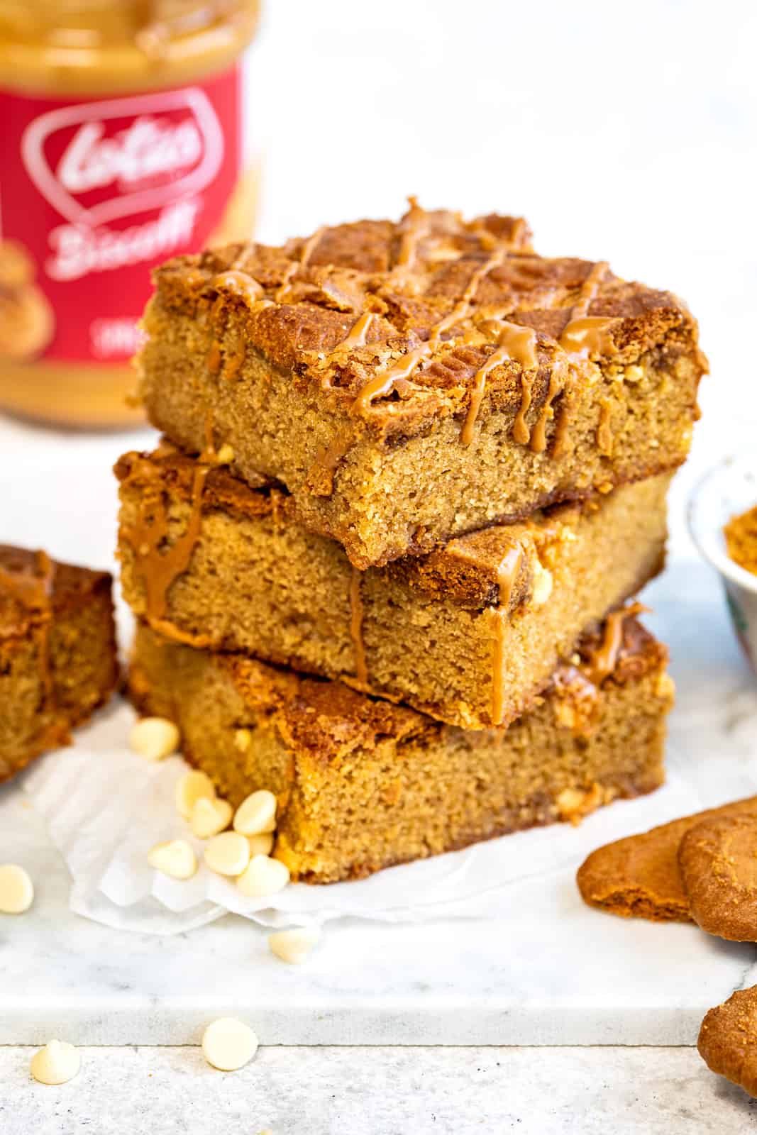 Side view of Biscoff blondies, stacked on a white board