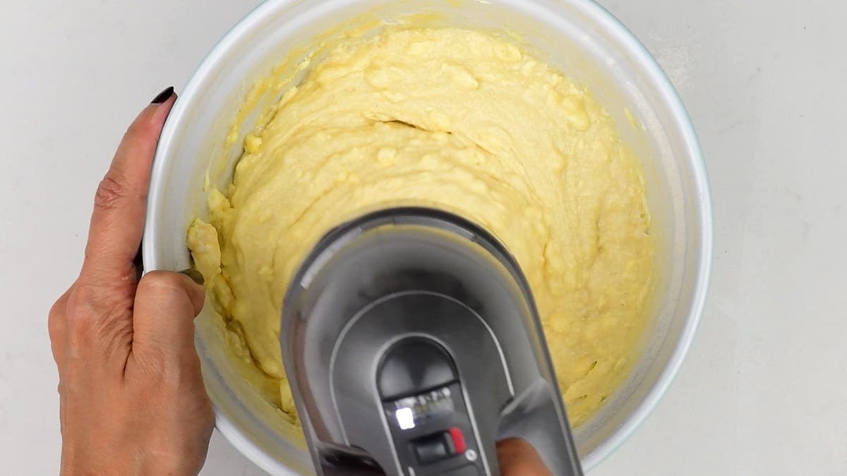 Beating sponge cake ingredients using a hand mixer