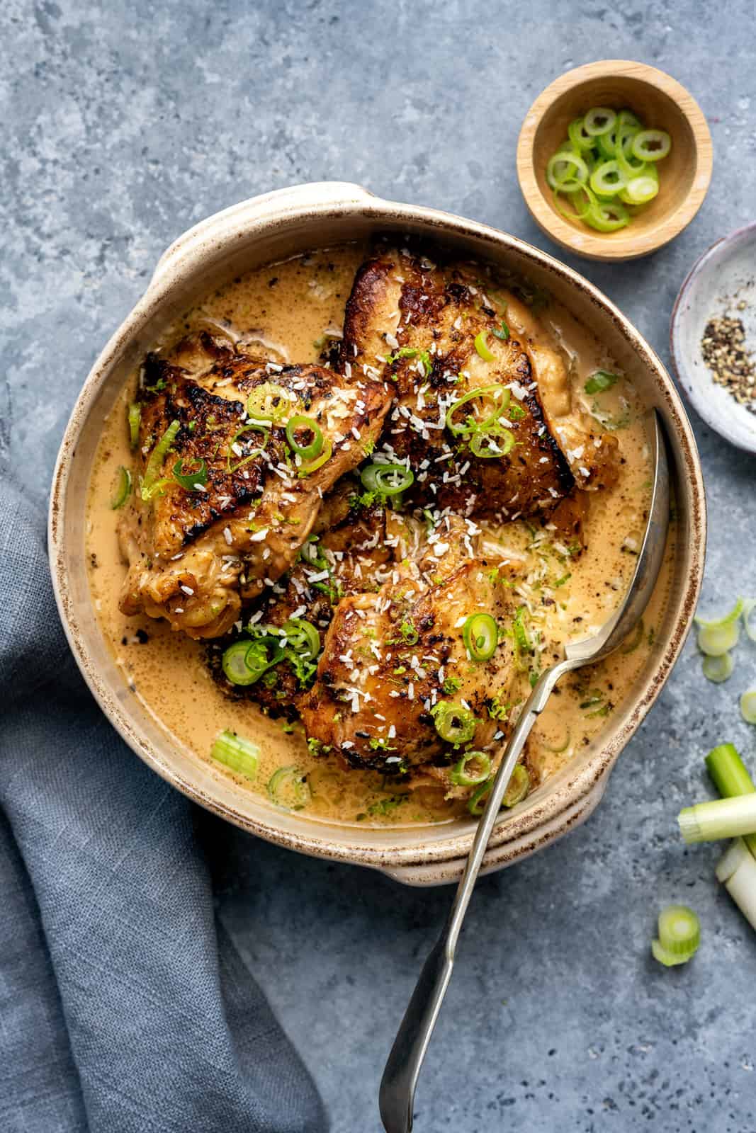 Keto chicken adobo in a bowl garnished with spring onions