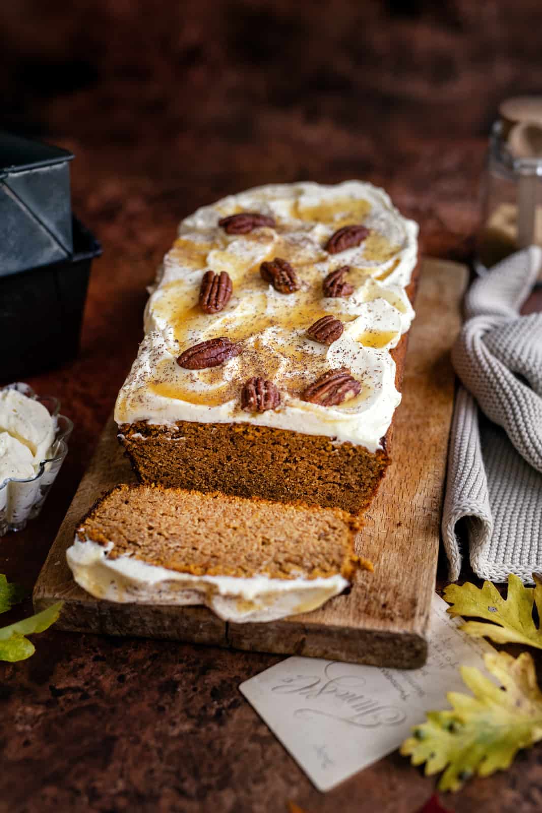 Low carb pumpkin bread with cream cheese frosting on a cutting board