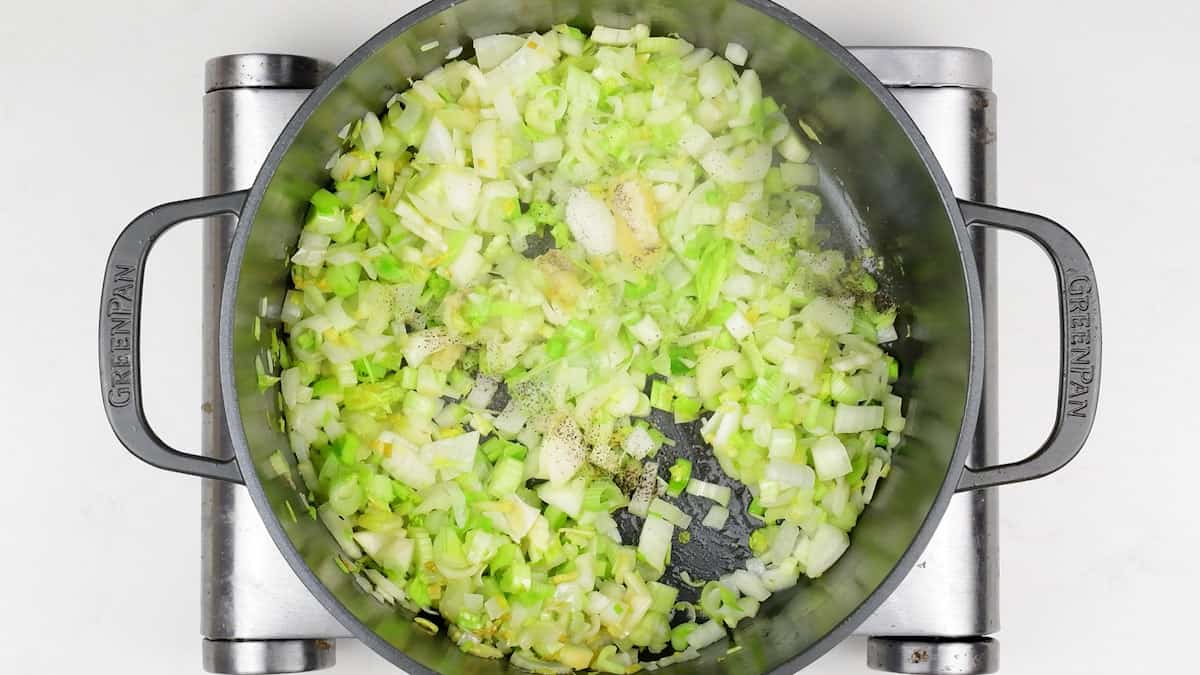 Cooking onions, leeks and celery in a pot