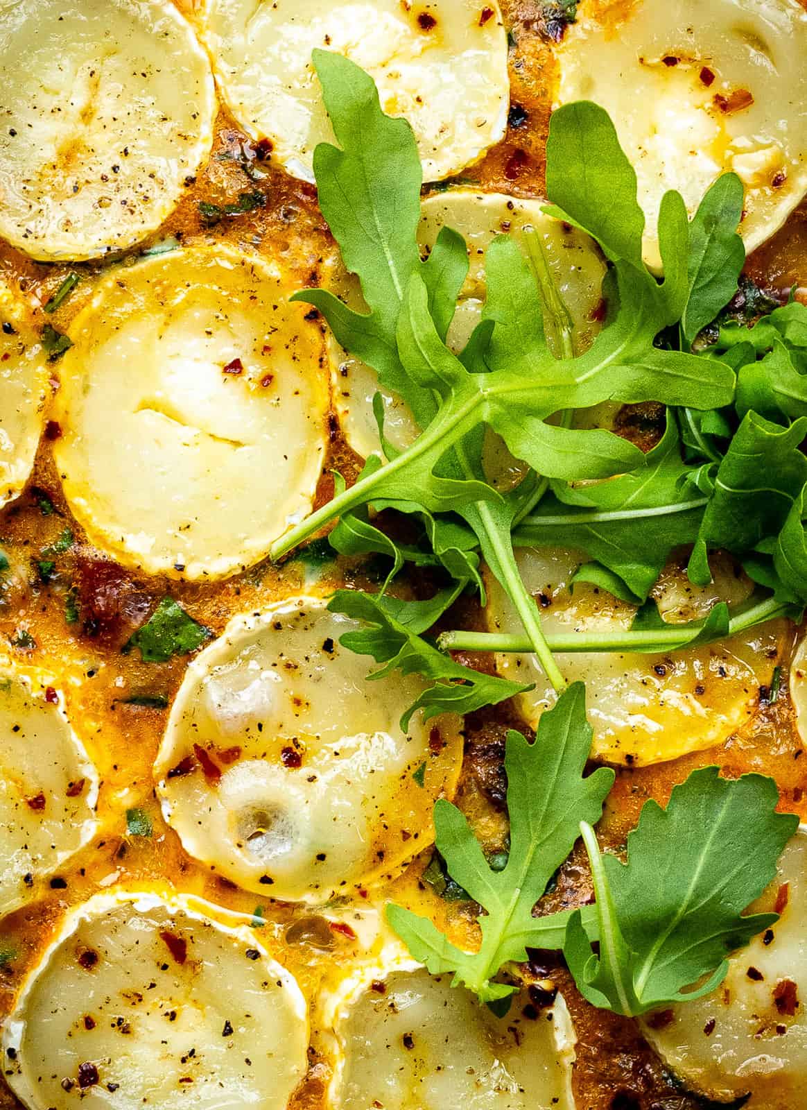 Close up on a slow cooker quiche topped with arugula