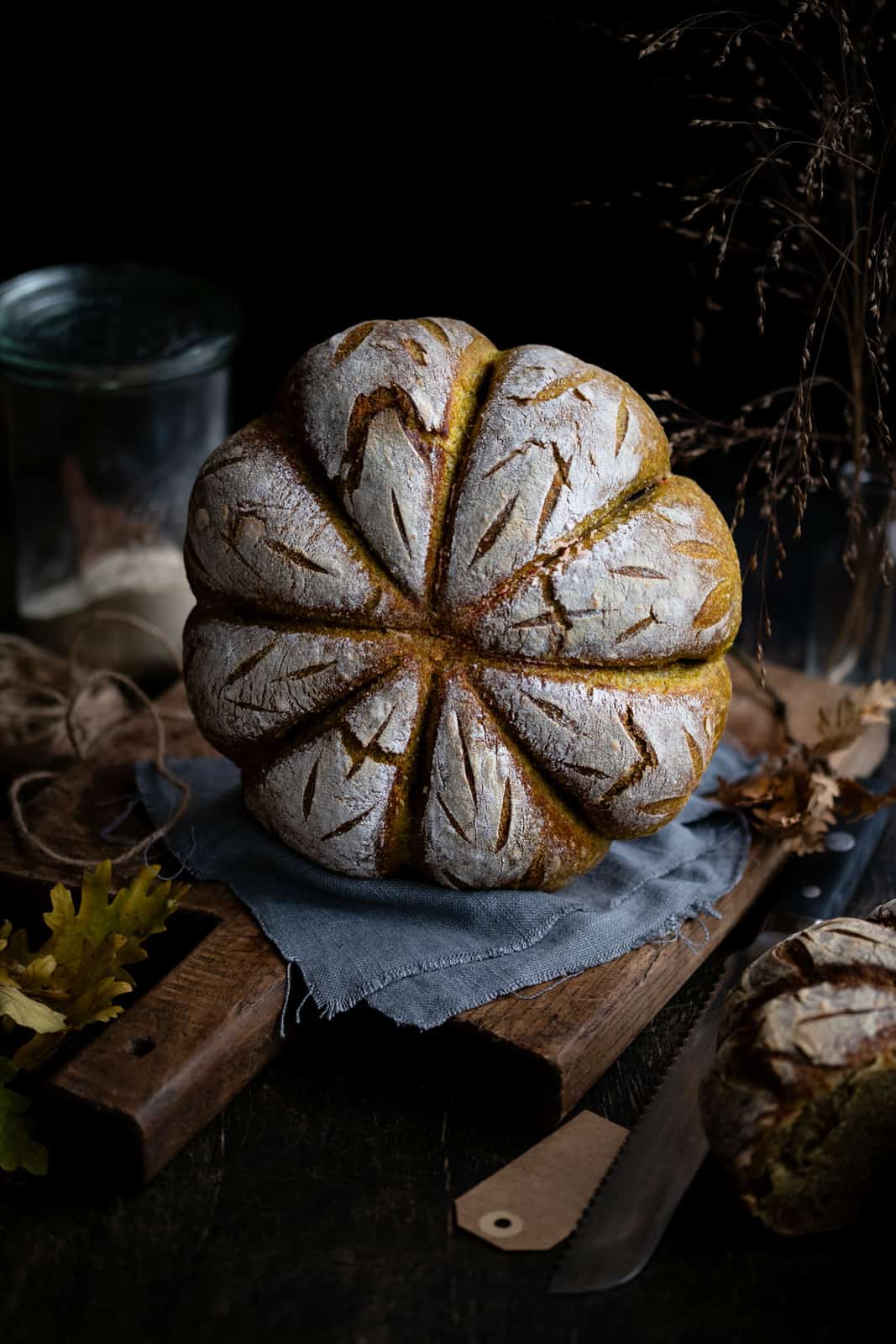 pumpkin shaped sourdough bread against a dark background