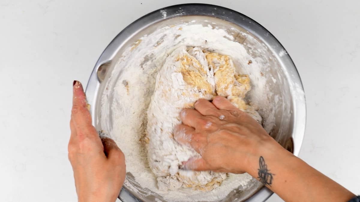 mixing sourdough pumpkin bread dough in a bowl