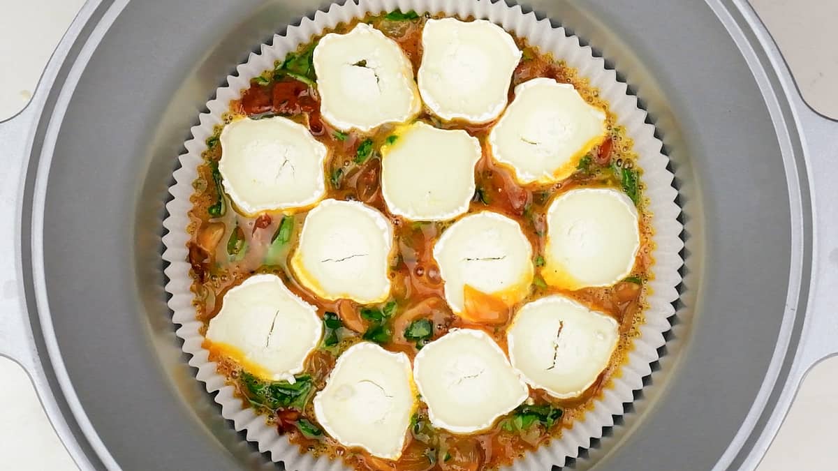 Crustless quiche topped with slices of goat's cheese