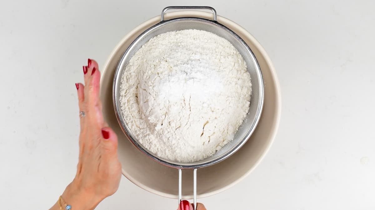 sifting flour, sugar, cocoa powder into a mixing bowl