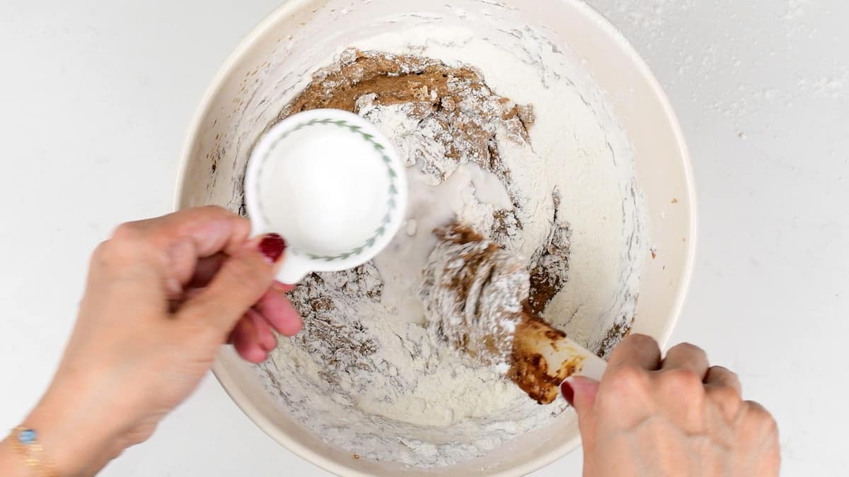 folding flour and milk into sticky pudding cake batter