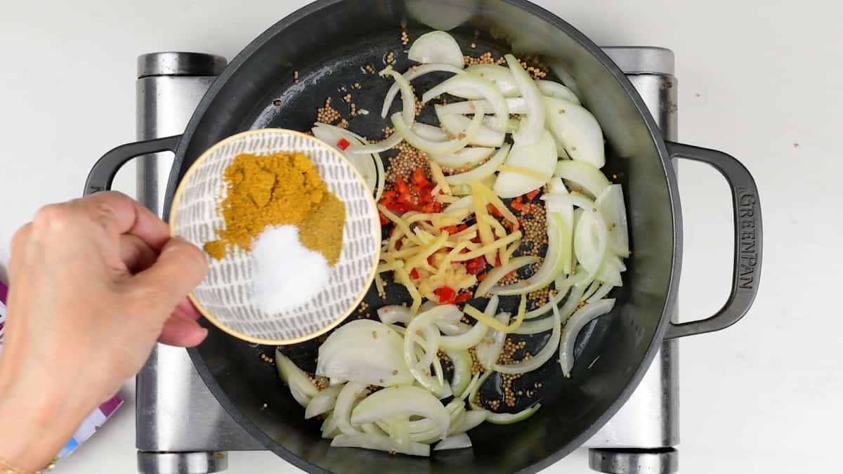 Pan frying onions, garlic, ginger and spices in a pot