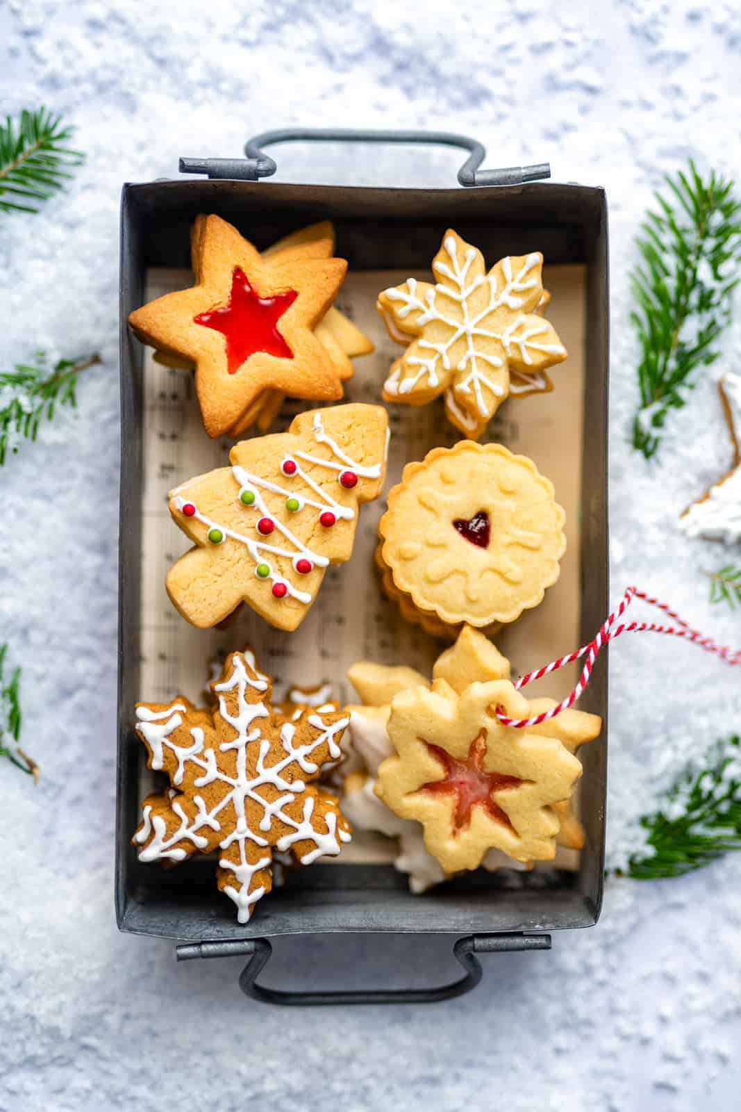 Assortment of festive Christmas cookies including gingerbread cookies, sugar cookies and stained glass cookies