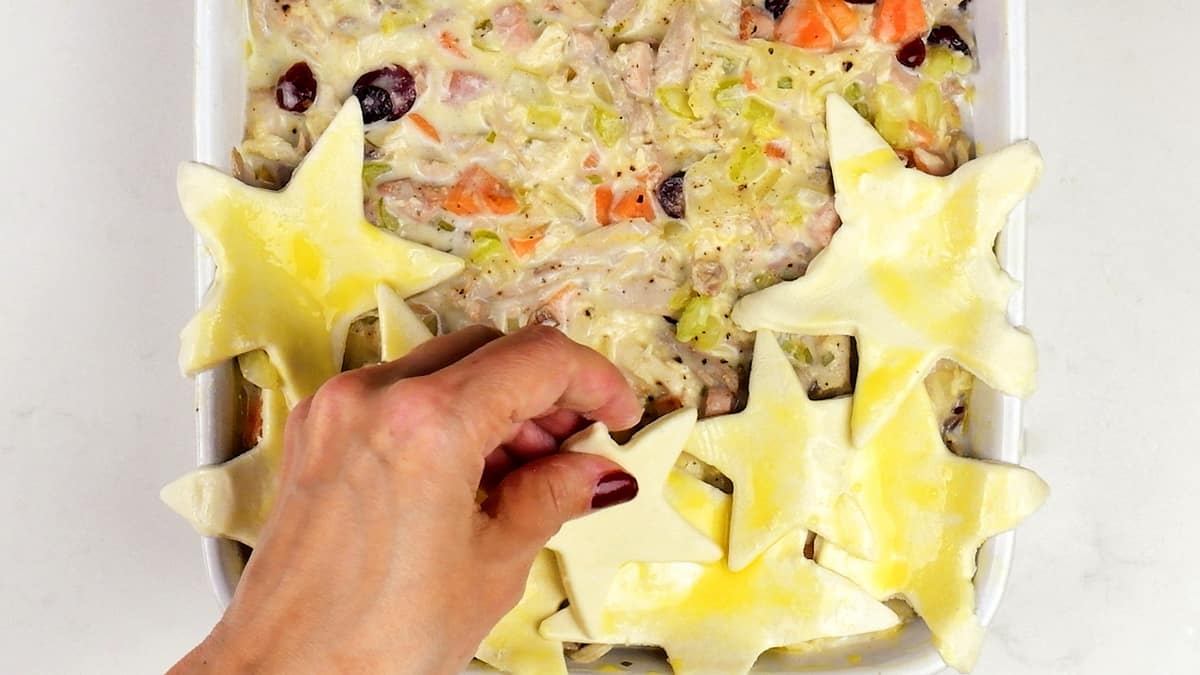 Covering turkey pie with puff pastry stars