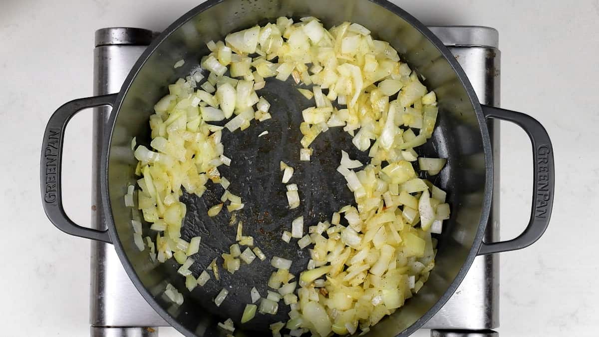 cooking diced onions in a Dutch Oven