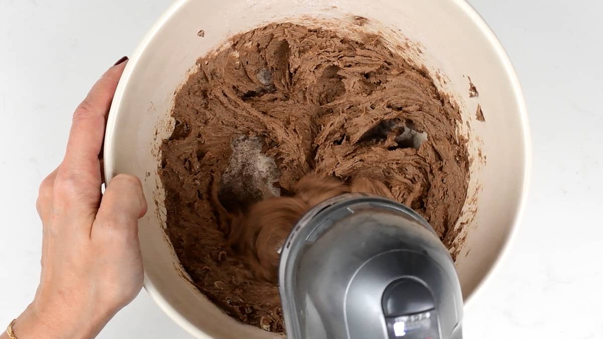 Beating ingredients for chocolate pudding in a mixing bowl