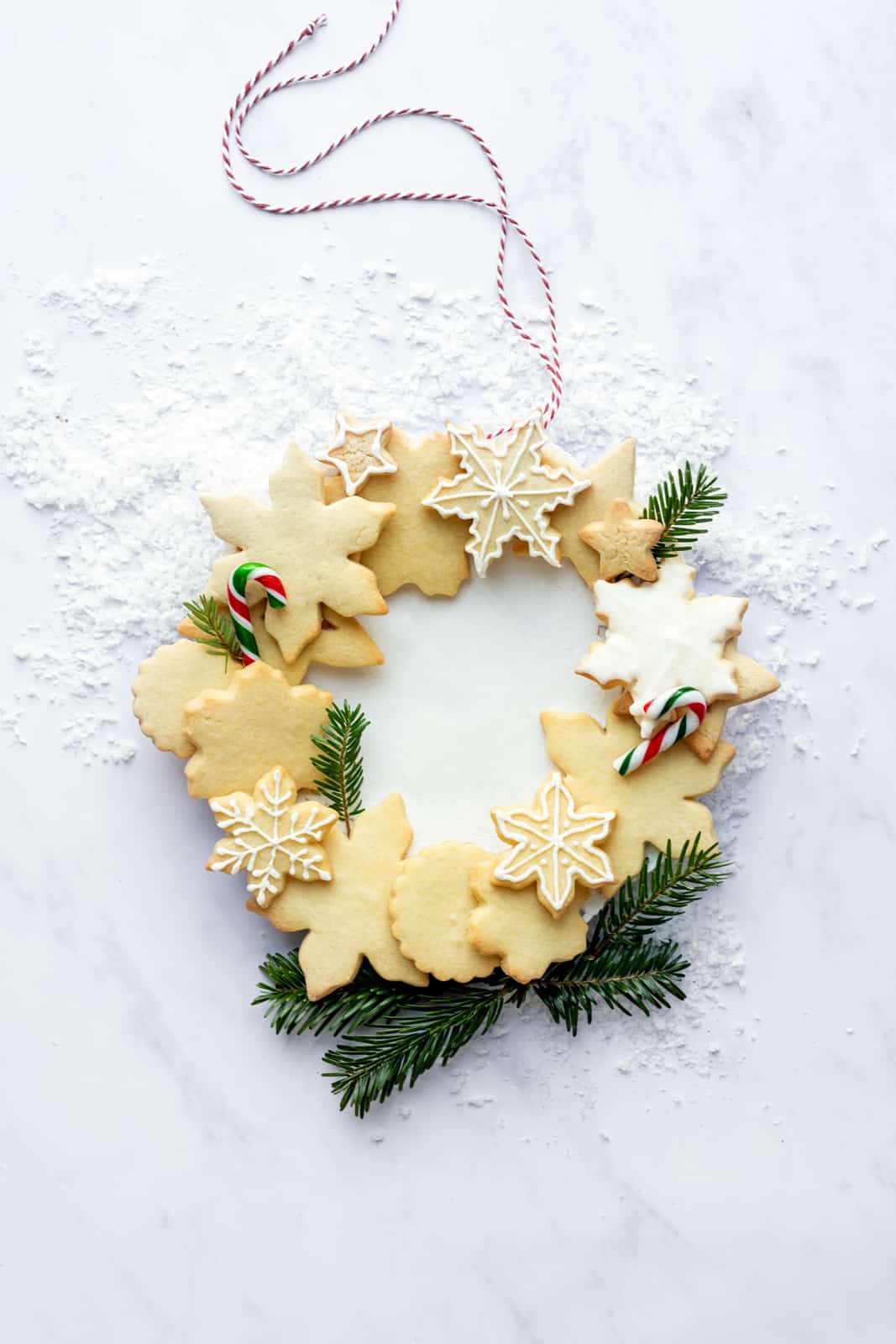 Cut out Christmas sugar cookies arranged in a wreath shape