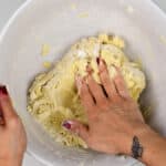 Kneading sugar cookie dough in a bowl