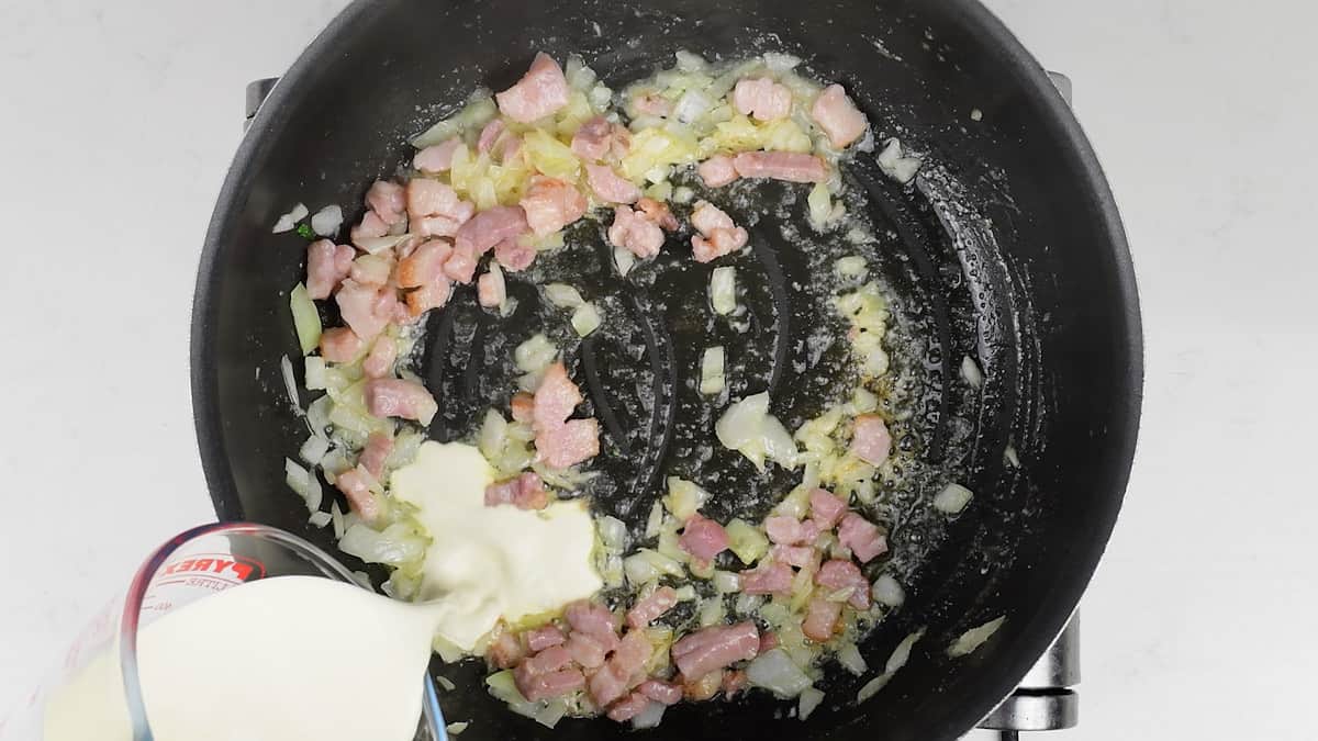 making Alfredo sauce in a pan