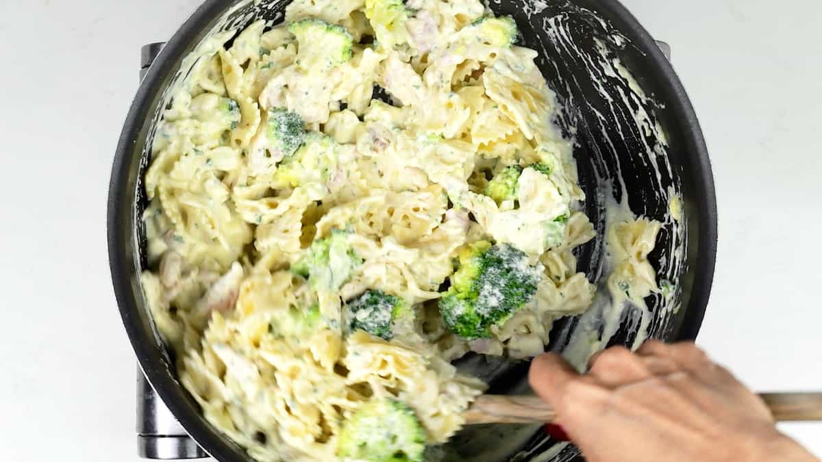 stirring pasta, broccoli and leftover roast turkey into creamy sauce